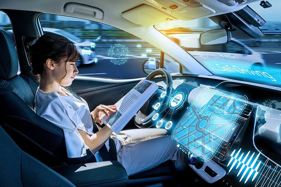 Women reading a book while riding self driving car
